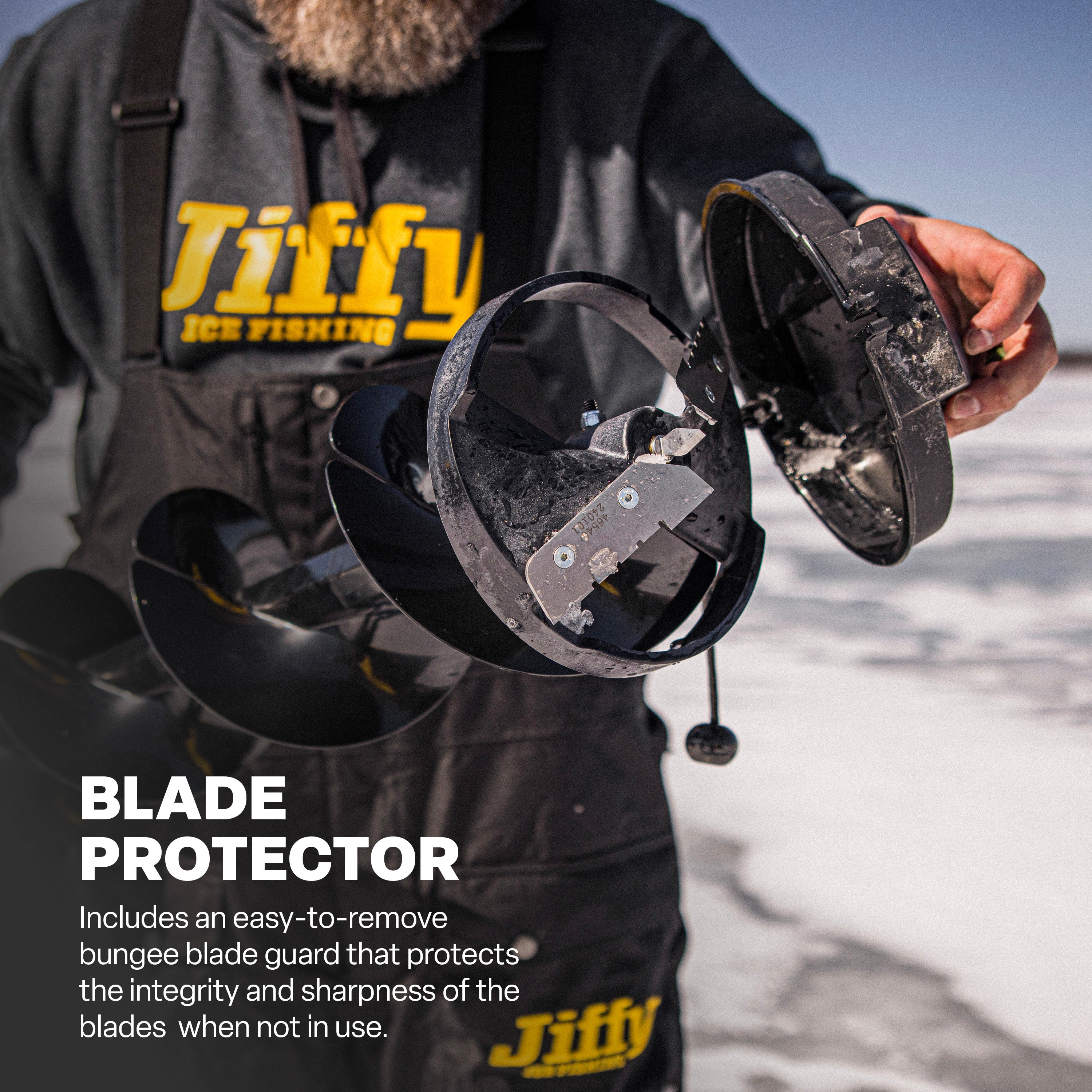 Jiffy auger bit with blade protector held by a person on an icy surface.