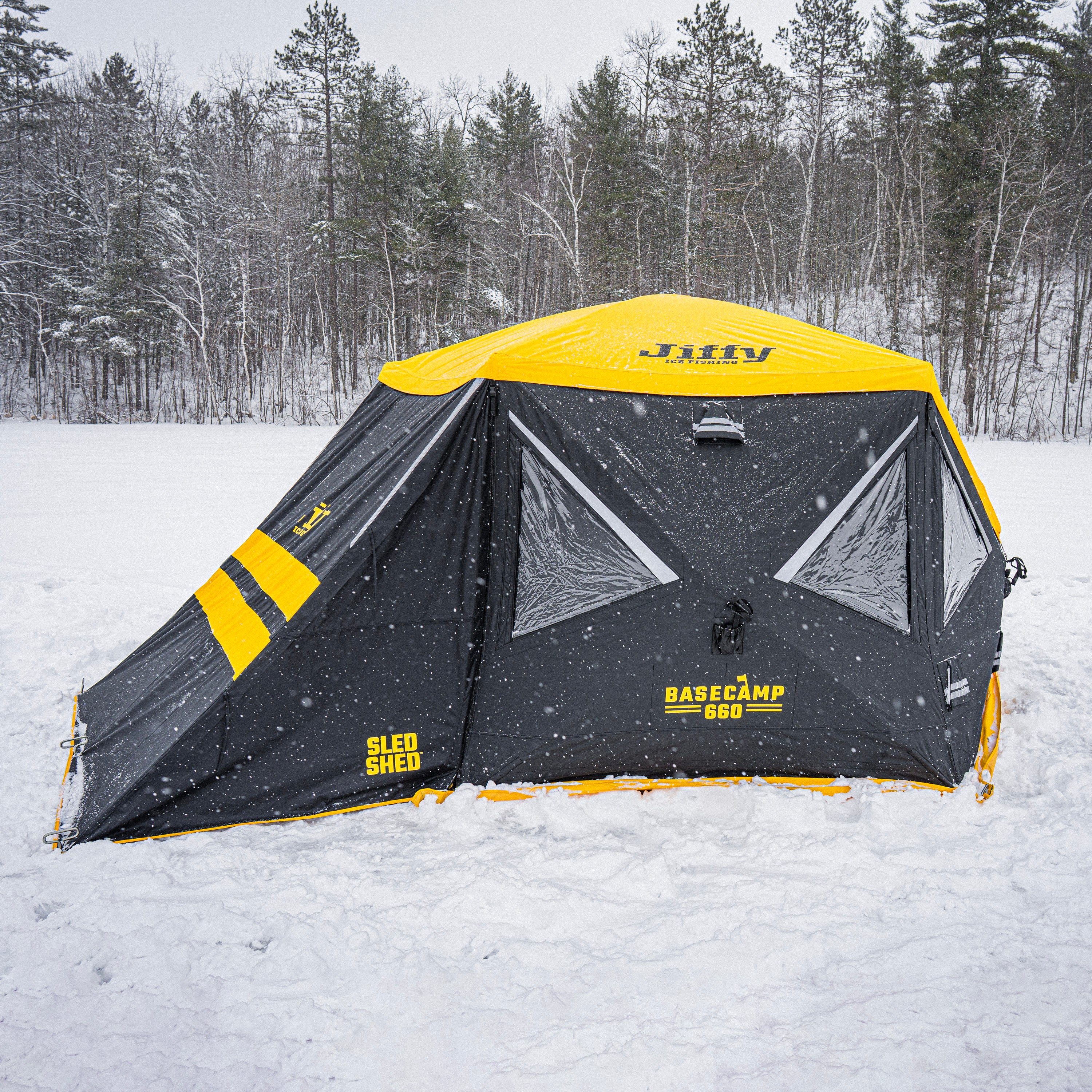Black and yellow Jiffy Basecamp 660 with Sled Shed in a snowy forest setting