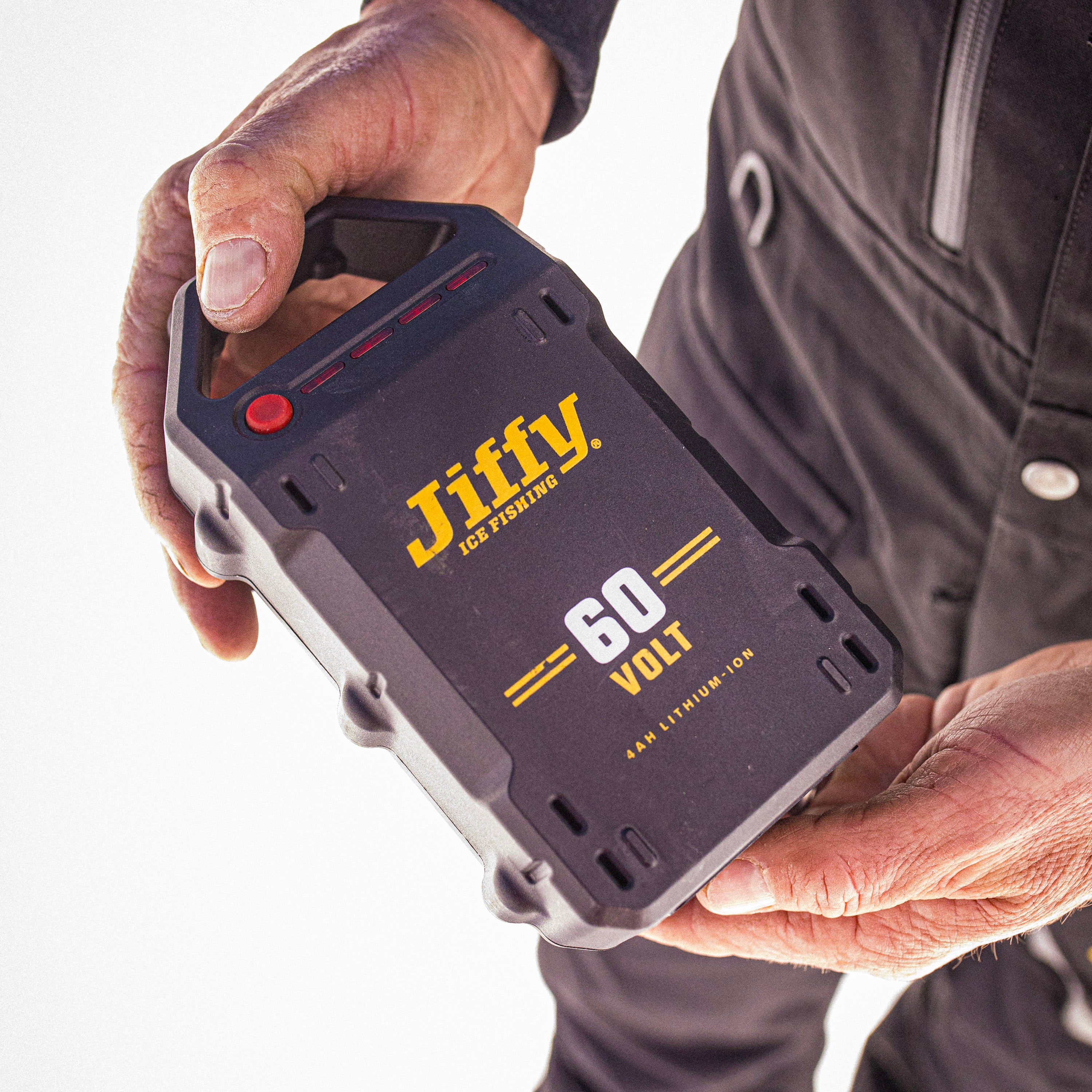 60-volt Jiffy battery held by a person with a white background