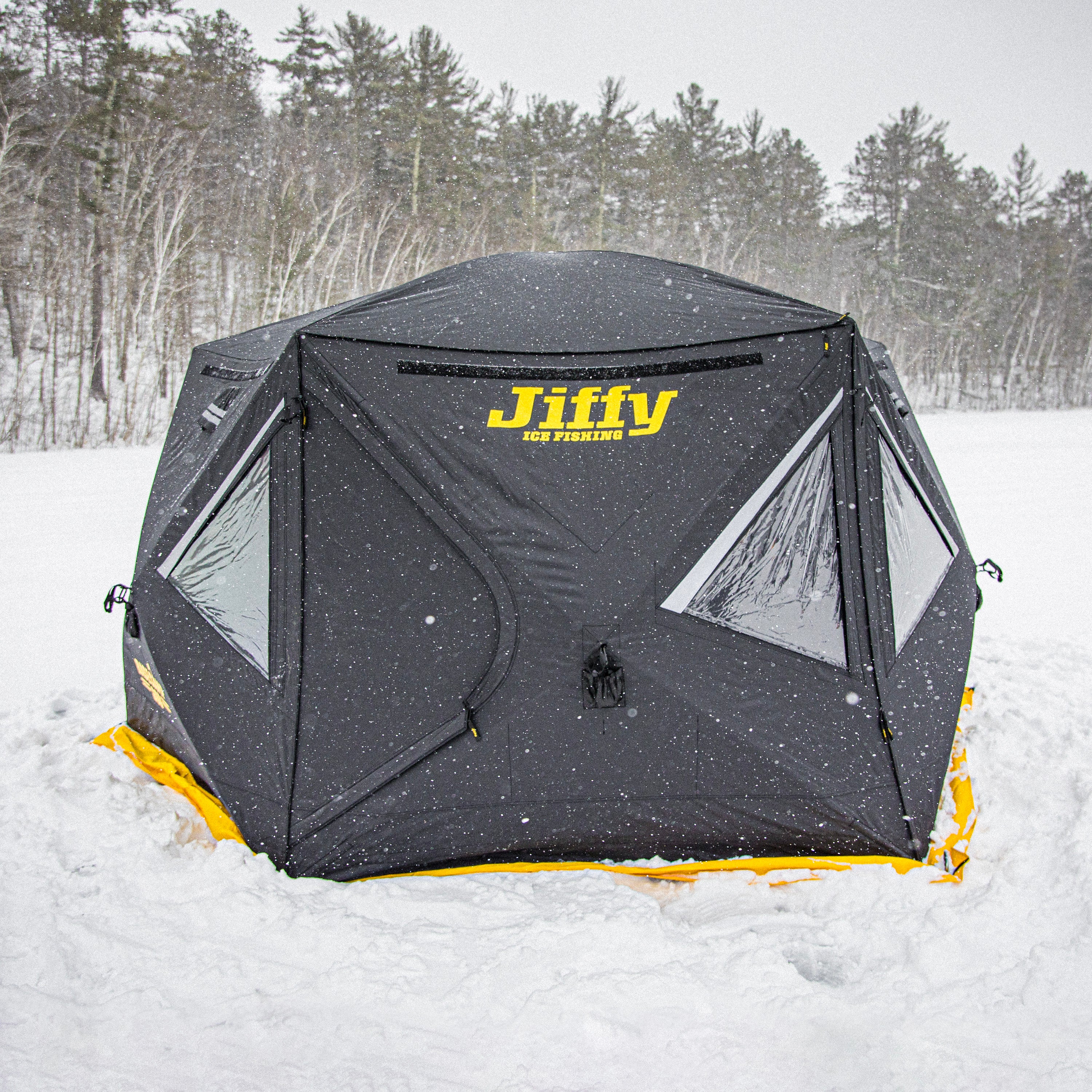 Jiffy ice fishing tent in the snow with trees in the background
